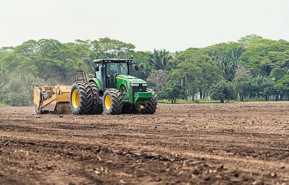 Topcon-guided tractor and scraper carrying out precision land forming